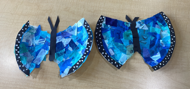 Two blue butterflies crafts made out of paper plates and tissue paper