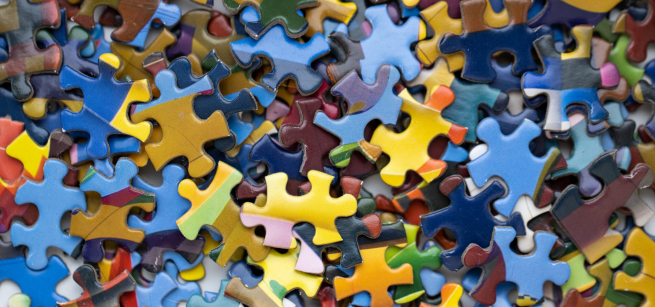 An assortment of colorful puzzle pieces spread out on a table.