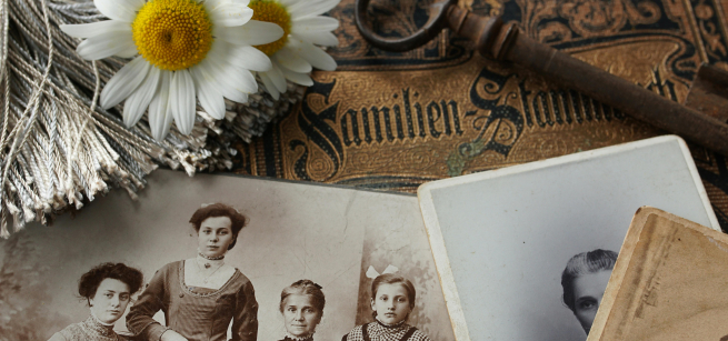 A vintage family album with black and white photos on top of it. 
