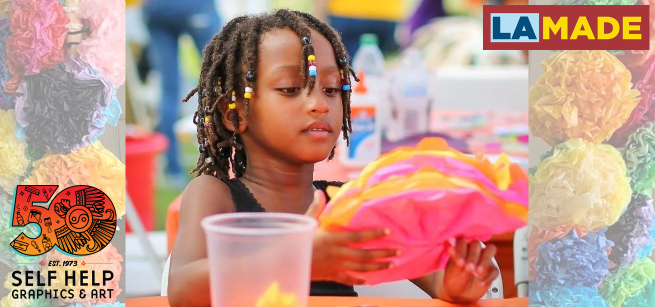 young girl making a paperflower