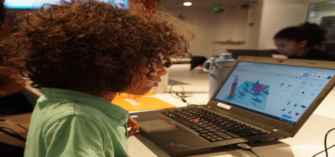 young boy working on a laptop