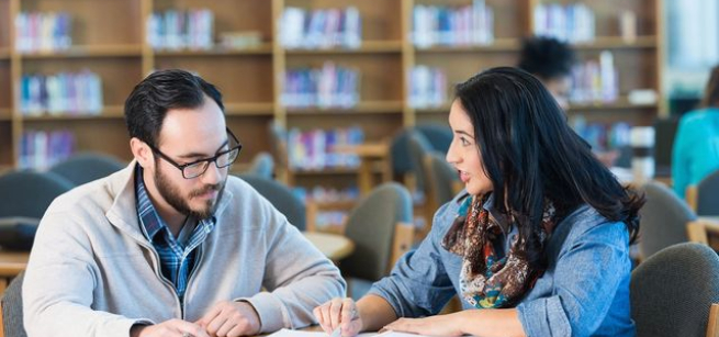Tutor helping student.