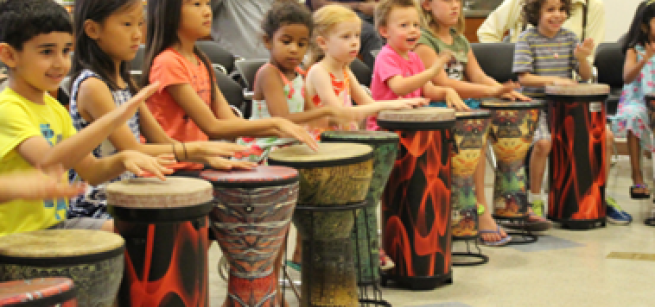 8 children playing congas