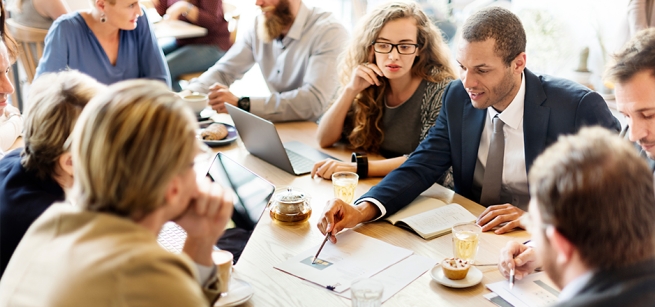 people gathered around a table having a financial discussion