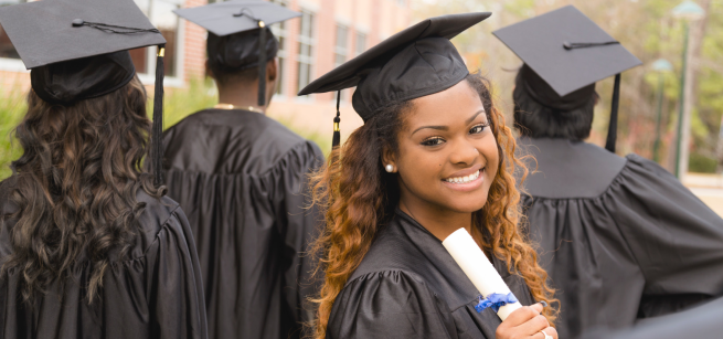 Young woman graduate with other graduates