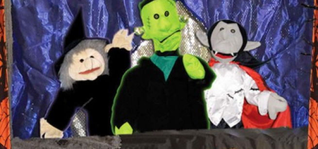 a witch, frankenstein, and dracula puppet standing and looking at the camera