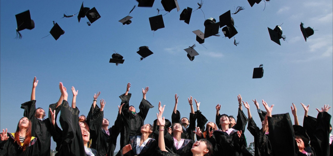 College graduates throwing caps in the air