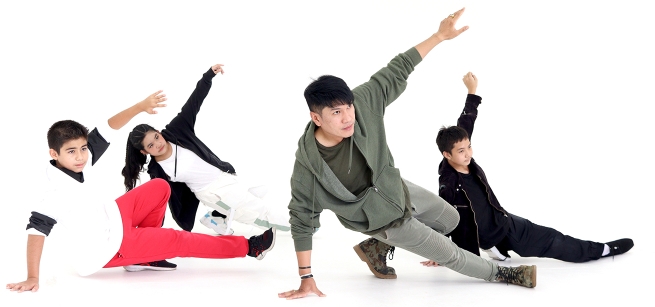 Four people showing a breakdance move