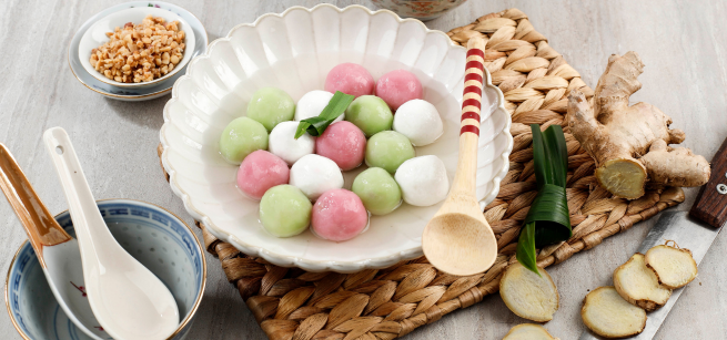 A place setting with a bowl filled with dessert dumplings.