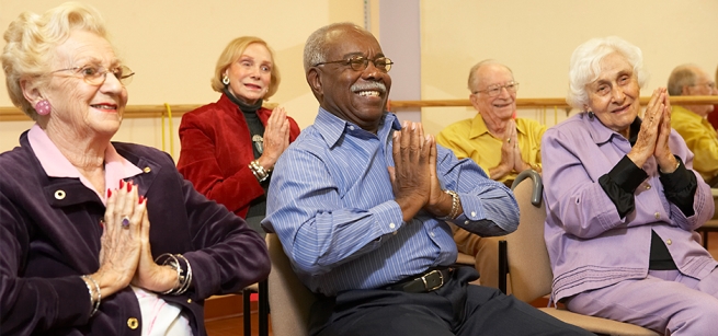 Adults doing seated exercises