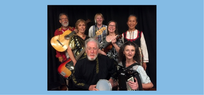 A group of seven folk musicians holding their instruments.