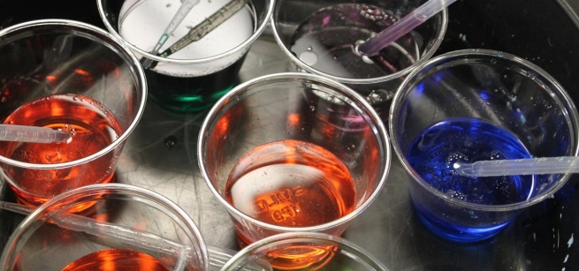 Cups of colored water with droppers