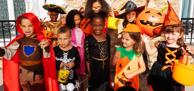 group of children dressed up in Halloween costumes