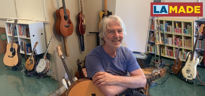 craig newton surrounded by musical instruments