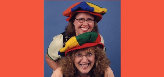 Two performers are wearing funny hats
