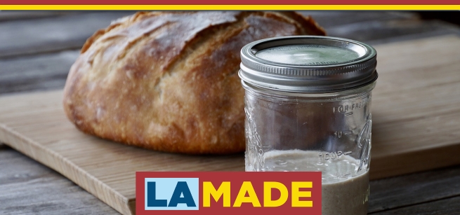 close up of sourdough loaf and starter