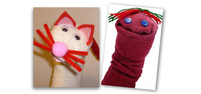 White sock puppet with pointy ears and whiskers and red sock with button eyes and yarn hair