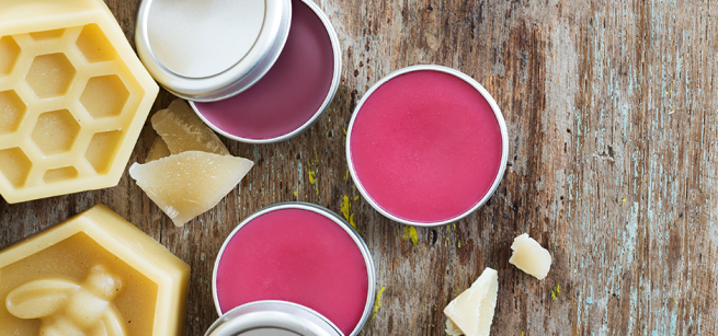Tins of pink lip balm and beeswax tablets