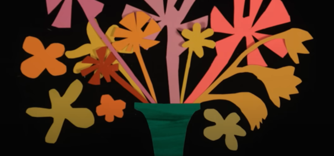 colorful flowers cut out of construction paper on a black background