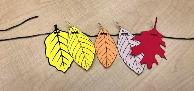 Leaf garland made with yellow, orange, brown, and red paper leaves