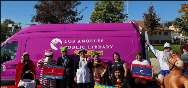 costumed people stand in front of library outreach van