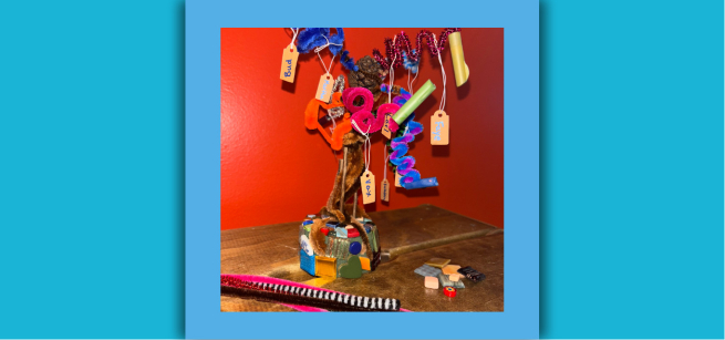 Image of a craft that looks like a tree made with recycled materials.