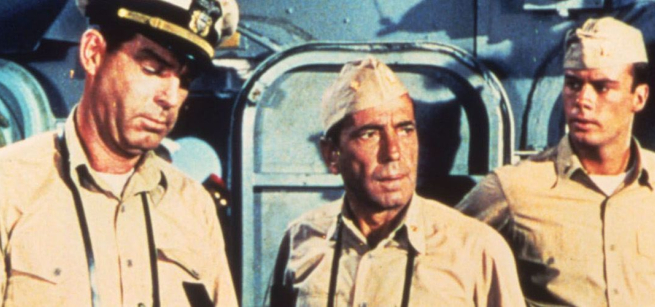three military men in naval uniforms on a the U.S war ship
