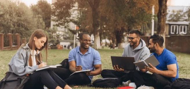 College Students Studying on Campus Lawn