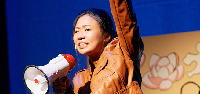 woman with megaphone on stage