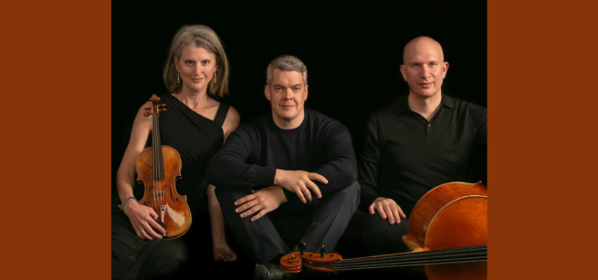 Three members of the Fibonacci Trio pose with instruments in front of a black background