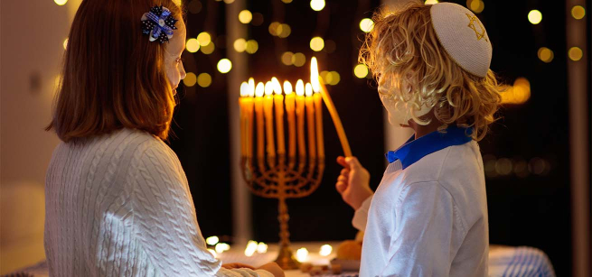children lighting a Menorah