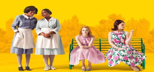 Two African American Women standing and two Caucasian women sitting