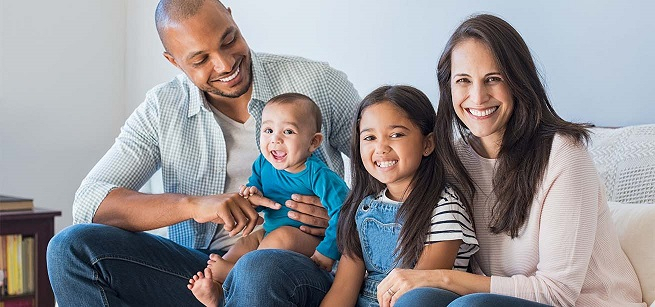 Mother and father sitting with two children