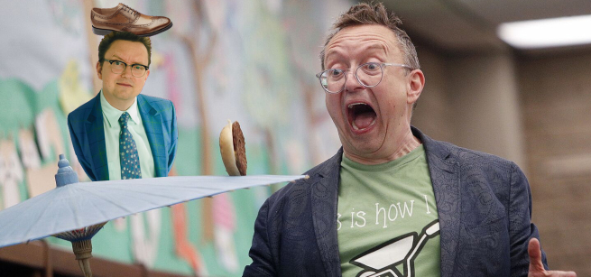 Michael Rayner balances a shoe on his head and a hamburger on an umbrella
