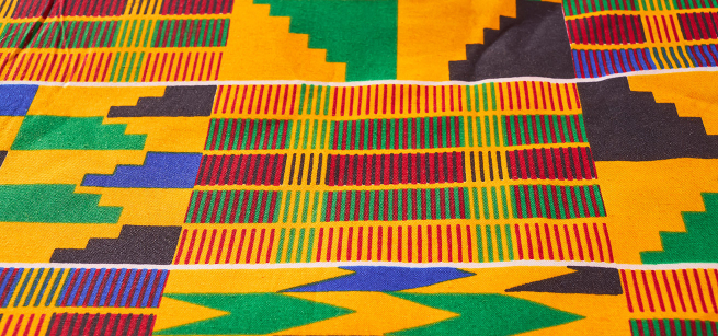 A close up photo of a piece of brightly colored kente cloth.