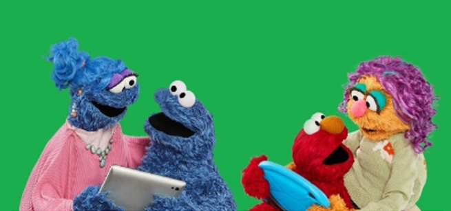 Four Muppets are talking while holding computer tablets.