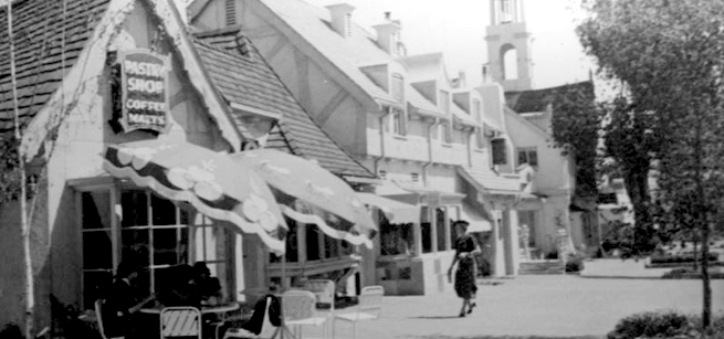 Woman walking down the sidewalk at Crossroads of the World on Sunset Blvd