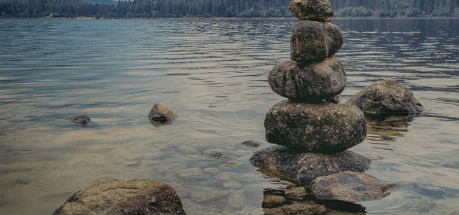 rocks stacked at the shore of a lake