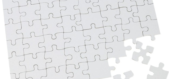 Unassembled white jigsaw puzzle pieces