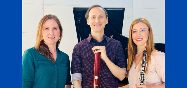 The three members of the Reedscape Trio pose in front of a piano.
