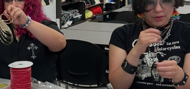 2 teens handling thread and ribbon and earrings
