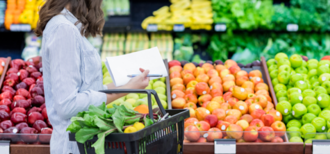 A woman shopping for vegetables in the produce section.