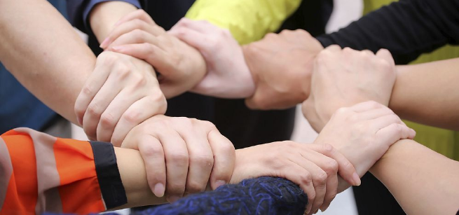 Hands interlocking wrists