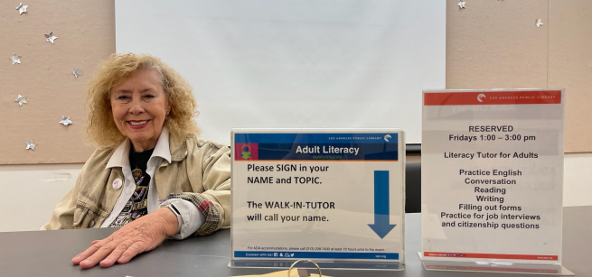 tutor with notebook and pen inviting students to register