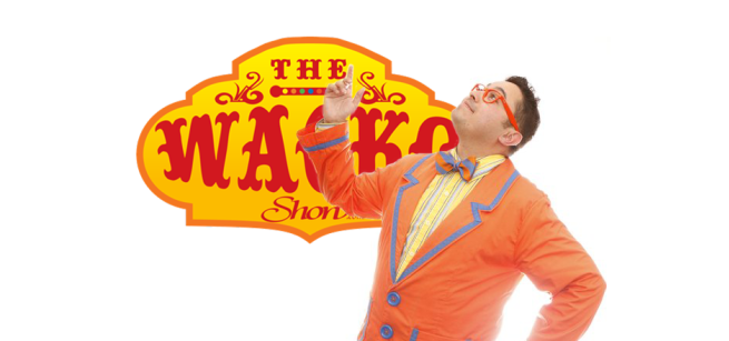 Image of a dark haired man with orange glasses and an orange jacket in front of a sign that says The Wacko Show.