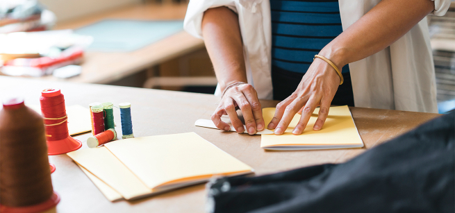 person binding a book 