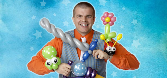 Male performer with several balloon creations in his hands