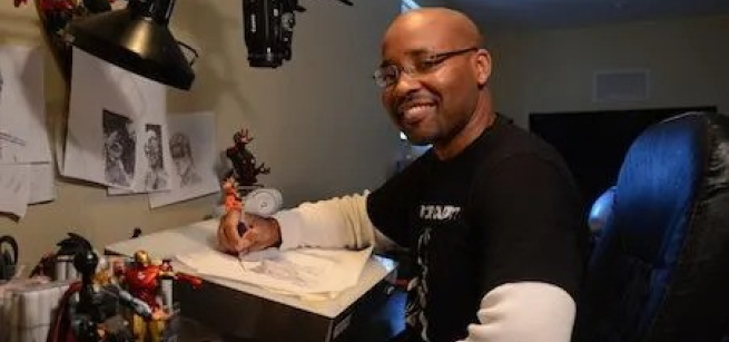 Evan seated in his drawing studio