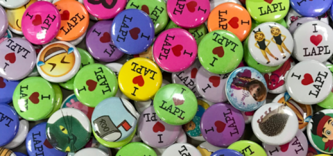 A variety of multicolored 1" buttons with text and images.
