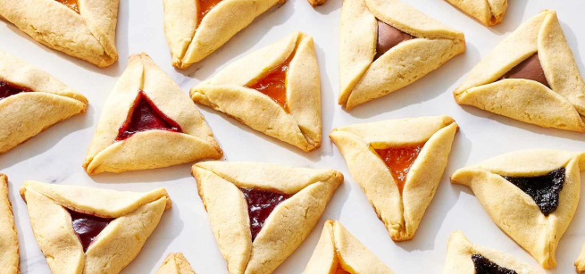 A plate of Hamantaschen (triangular jam-filled cookies)
